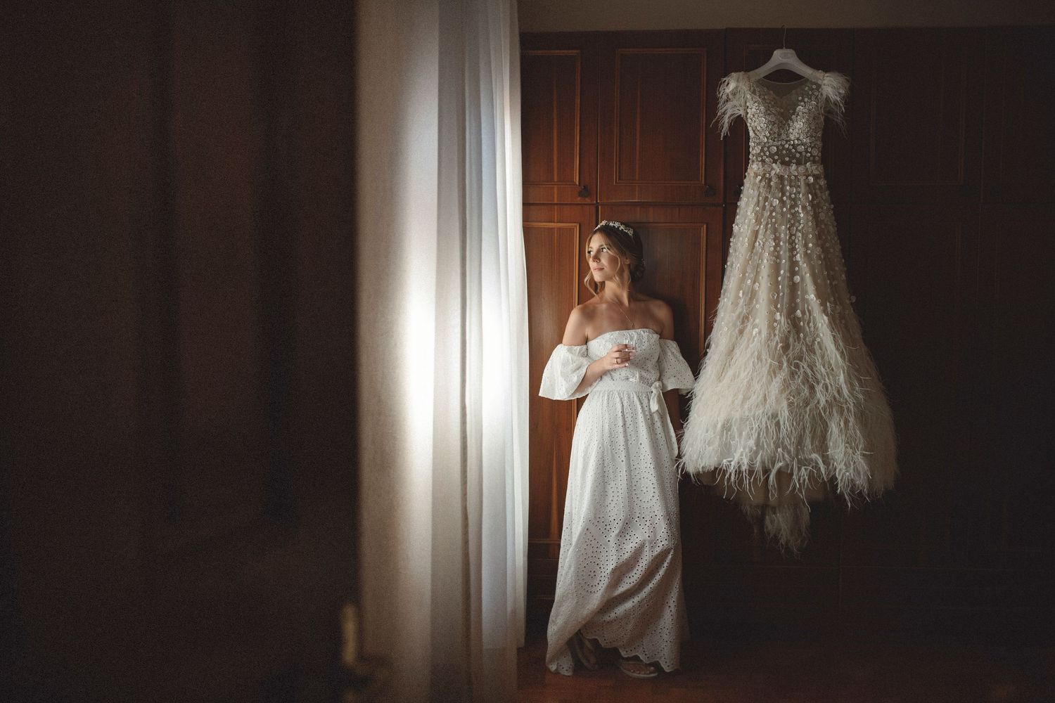 Cinematic bridal portrait capturing quiet emotions and soft window light during the wedding getting ready moments.