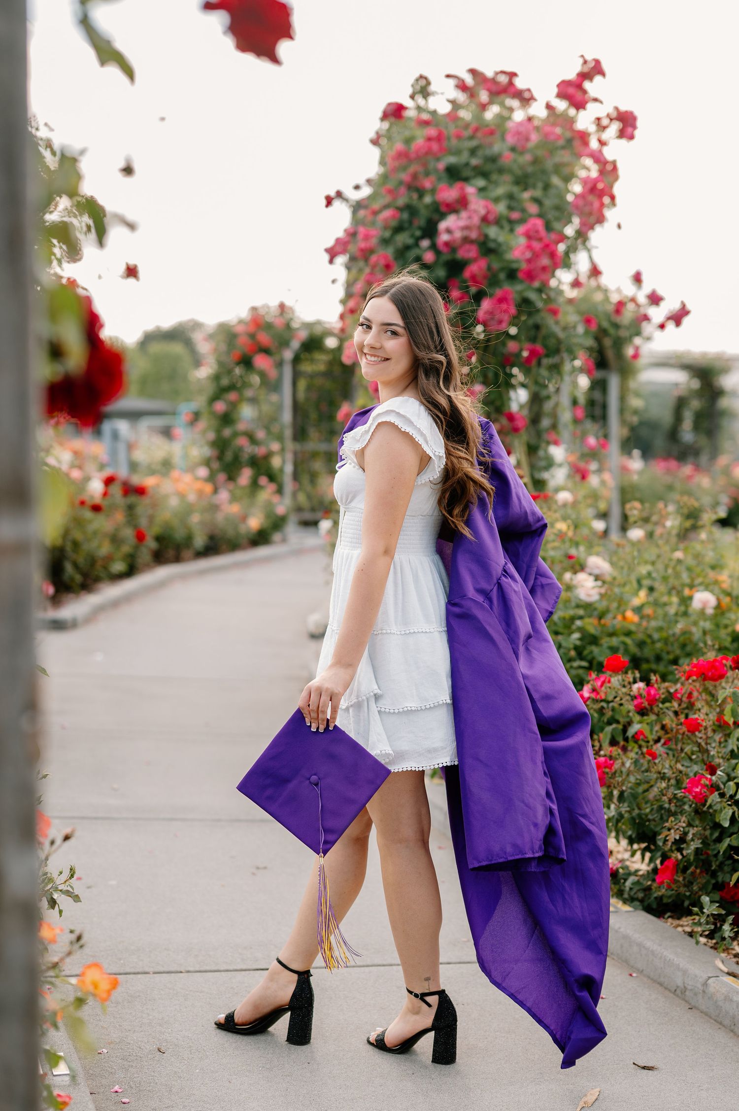 2026 senior with her cap and gown at WSU Demonstration Gardens in Tri-Cities, WA