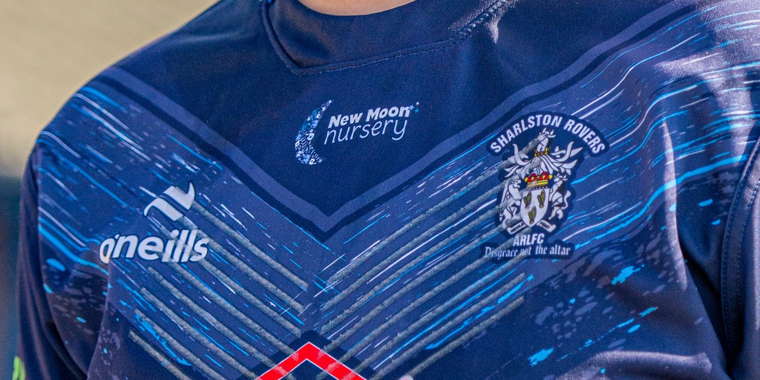 Blue O'Neills rugby league jersey with New Moon Nursery sponsor and club crest detail closeup.