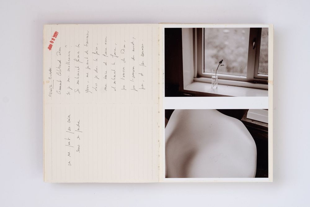 Open journal with handwritten notes beside two photos of a window and a white ceramic object.
