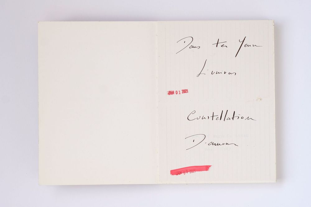 Open book with handwritten inscription reading For You, Lemais, Constellations, Damour on white pages.
