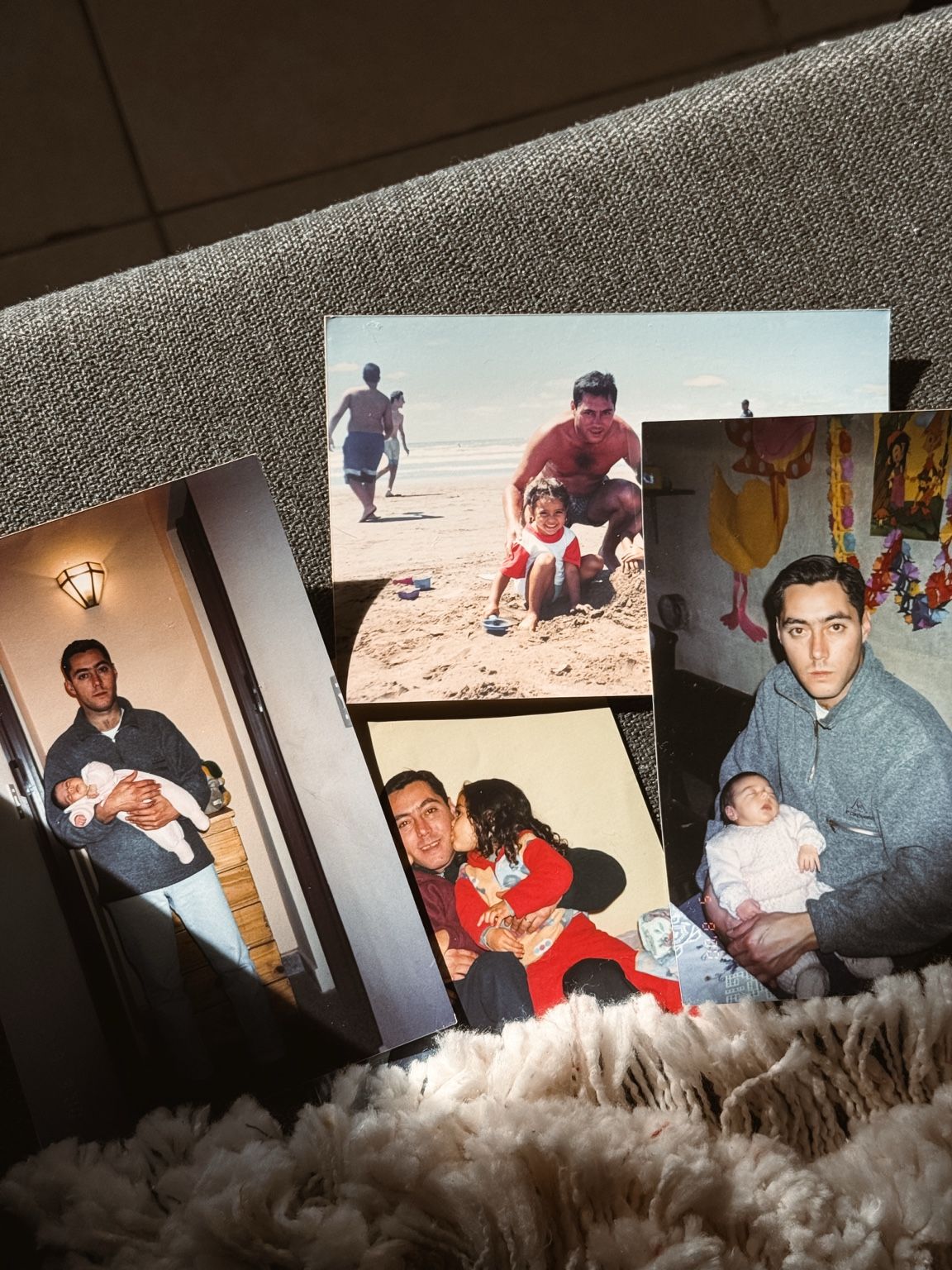 A collection of four family photos arranged on a textured surface, showing candid moments at the beach and indoors.
