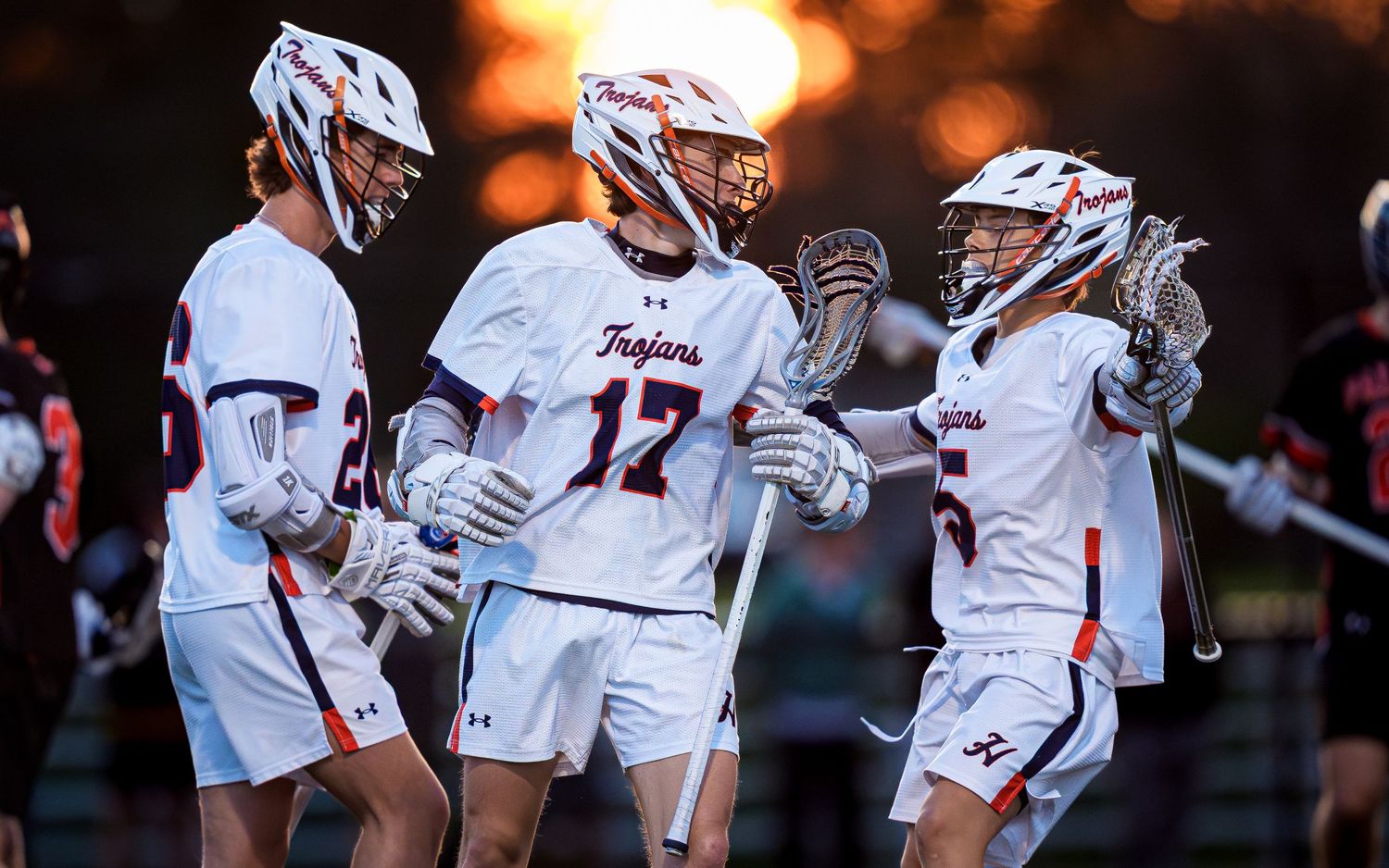 Hershey Trojans boys lacrosse players celebrating a goal against Palmyra, by Deanna Fox, SportsFox Photography based in Hershey PA