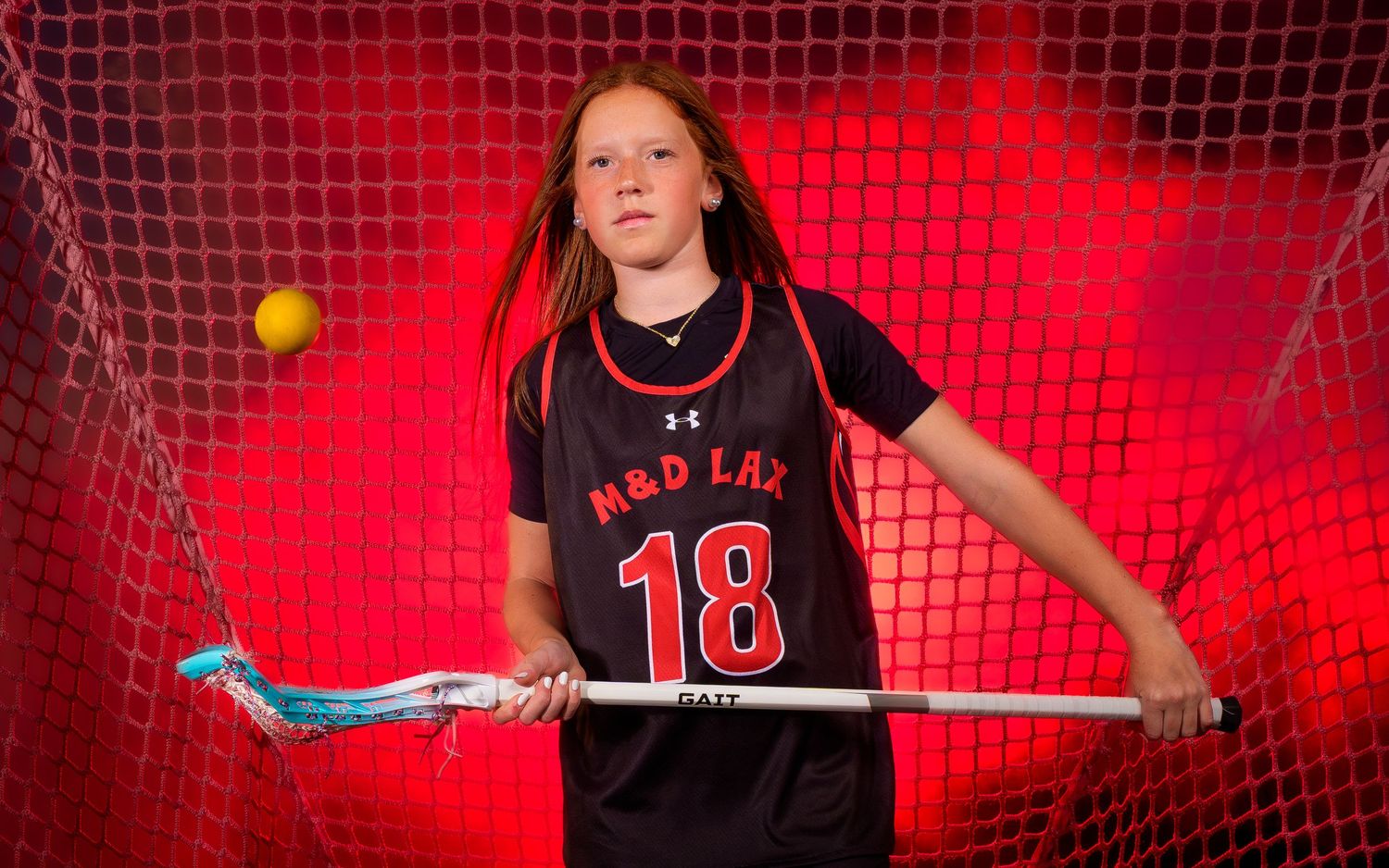 Regan Fedash M&D club lacrosse Media Day portrait with red fog handling the ball, by Deanna Fox, SportsFox Photography based in Hershey PA
