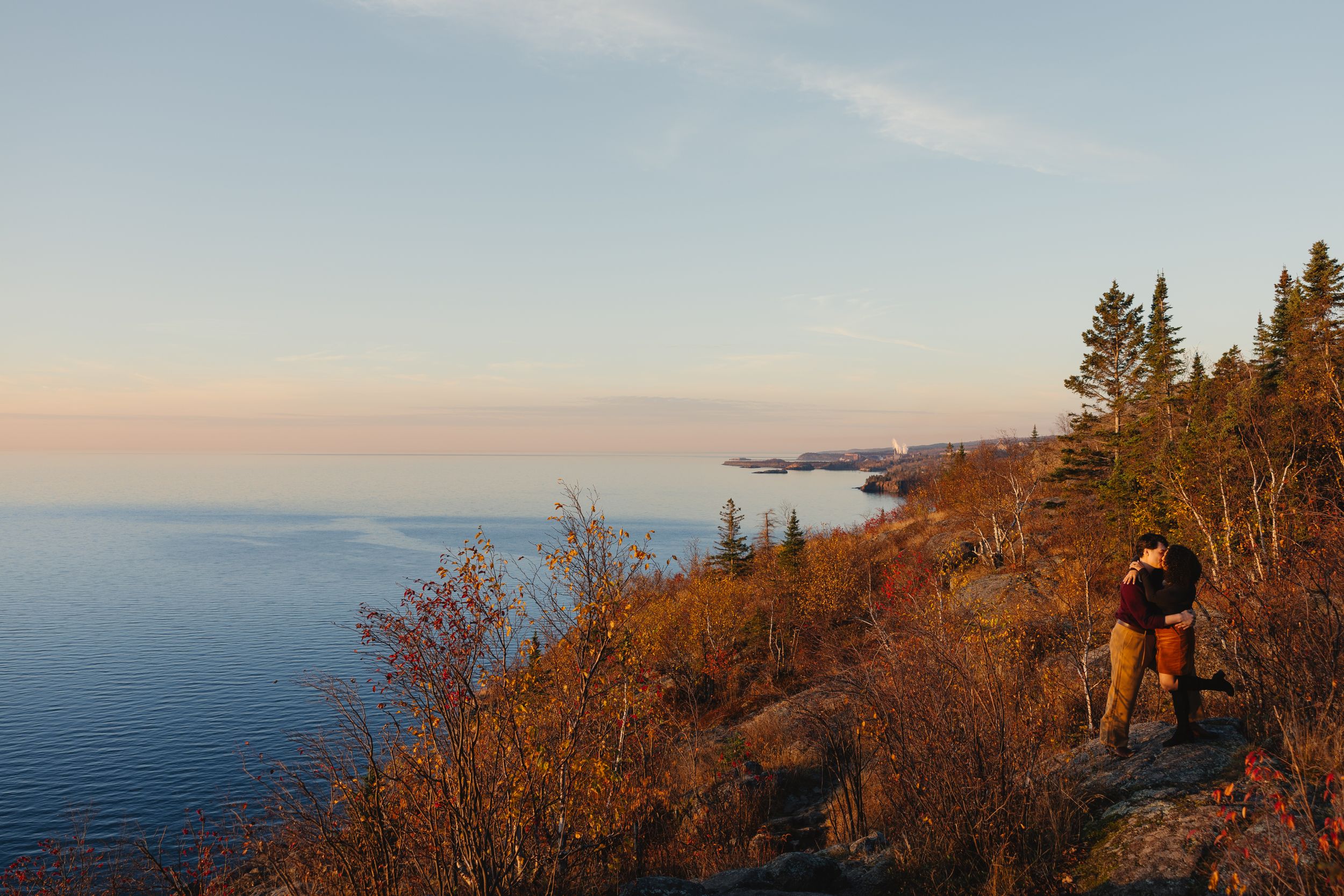 Scenic panoramic oceanside view with autumn foliage and dramatic sunset along a rocky coastline. Twin Cities, Decorah Iowa wedding photograp