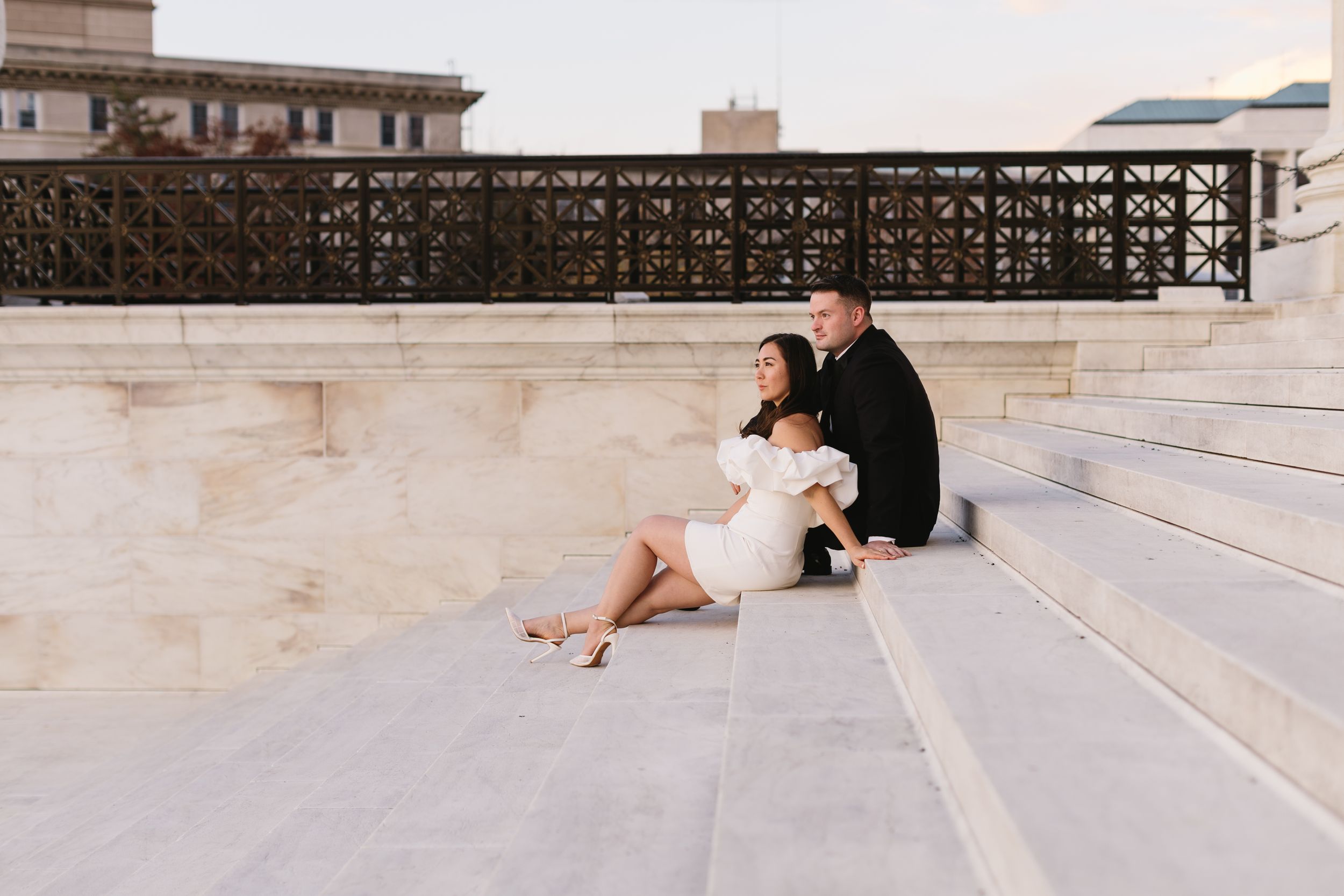Wedding couple sitting together on stone steps at sunset. Twin Cities wedding photography.