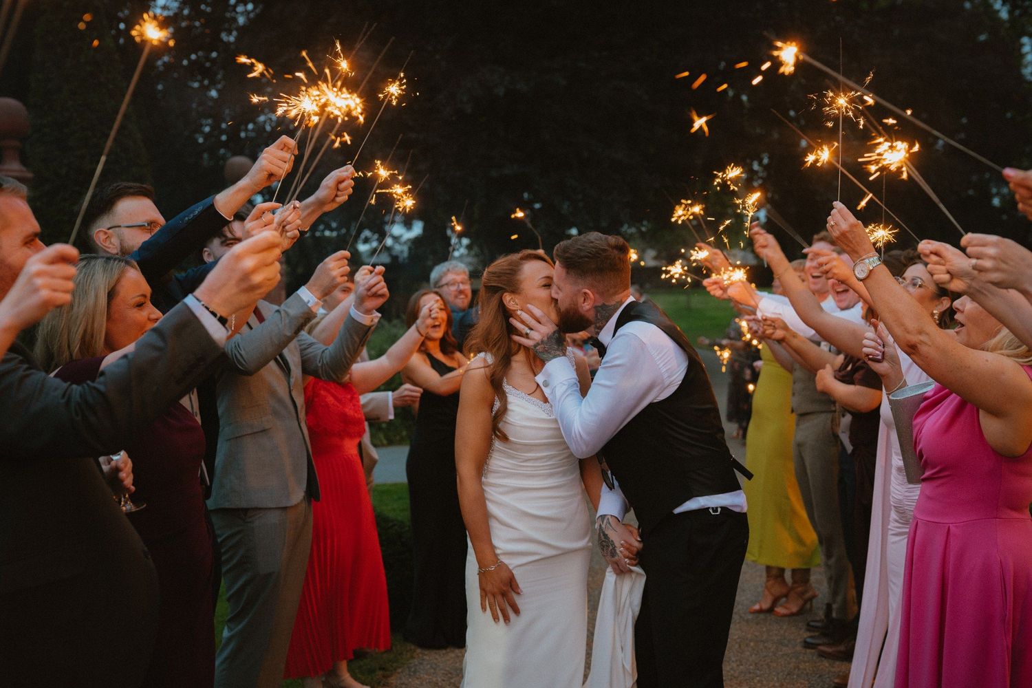 Bride and groom kissing during a sparkler celebration at Tankardstown House.