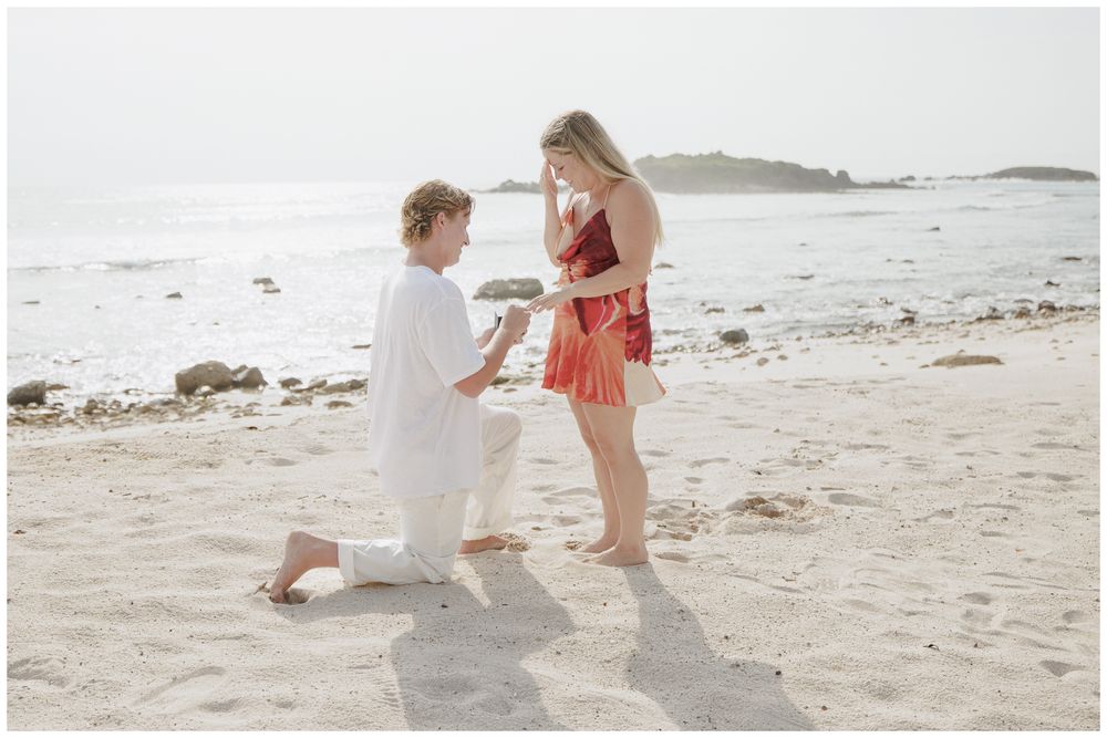 Punta Mita Proposal Photography featuring a Groom proposing to his bride-to-be on a sandy beach during golden hour.
