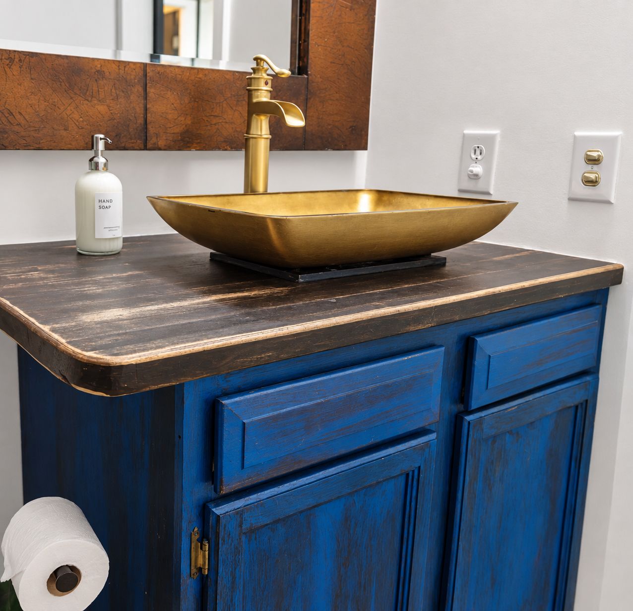 Rustic blue distressed bathroom vanity with dark wood countertop, gold vessel sink, and brass faucet.