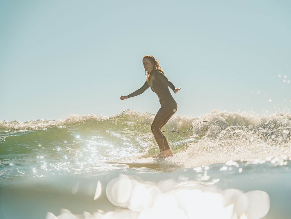 Girl looking angelic in light with Sunlight surfers Newcastle women's surfing group at Crescent Head Surf Camp out