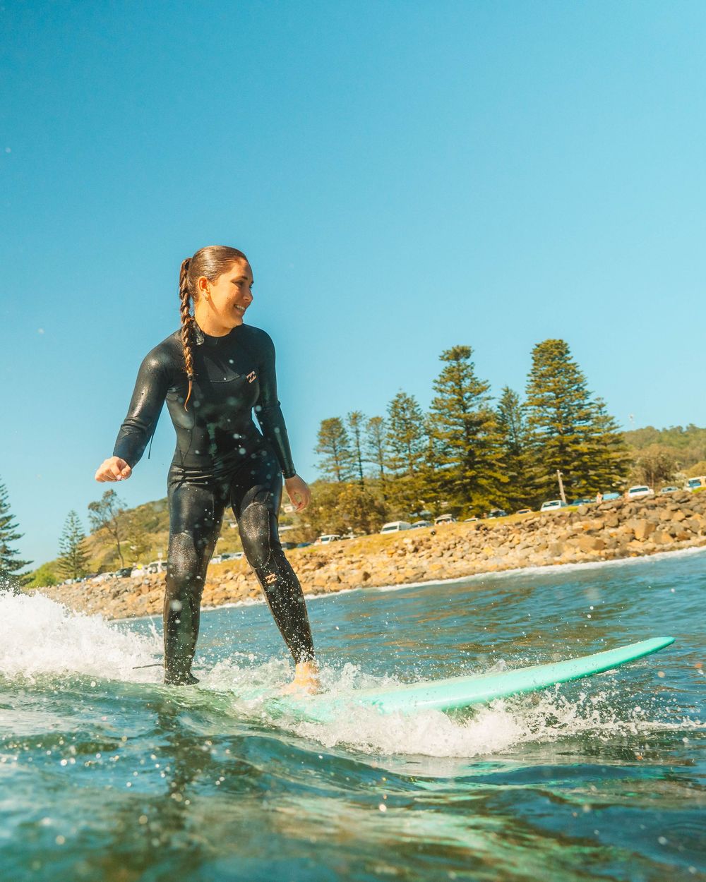 Girl smiling on a wave with Sunlight surfers Newcastle women's surfing group at Crescent Head Surf Camp out