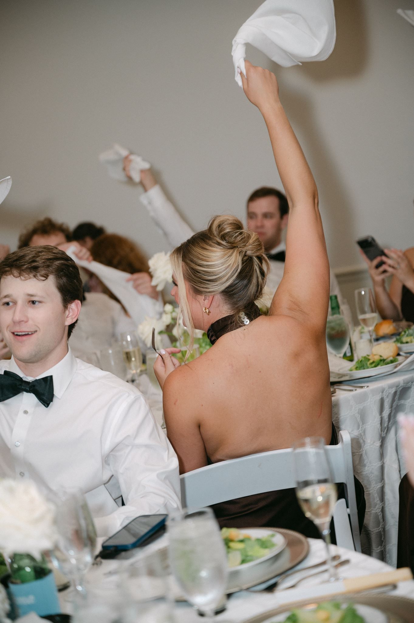 Guests cheering for bride and groom's grand entrance.