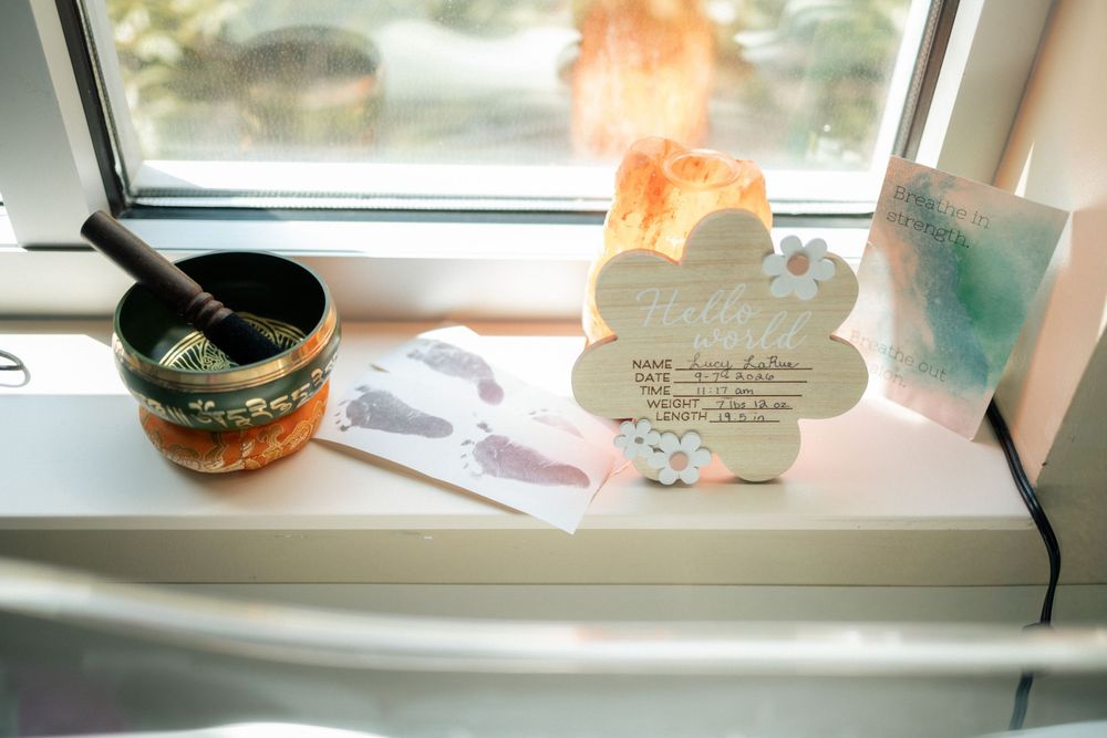 Serene windowsill display with singing bowl, Himalayan salt lamp, and watercolor art cards in soft natural light.