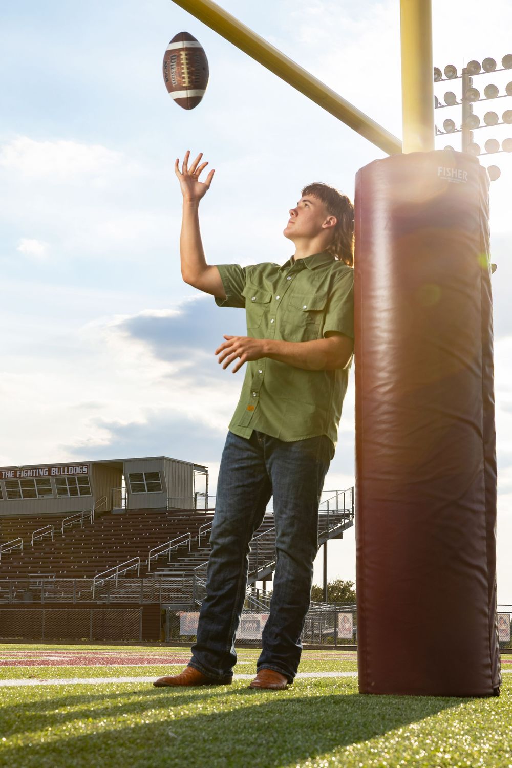 young man tossing a football in the air