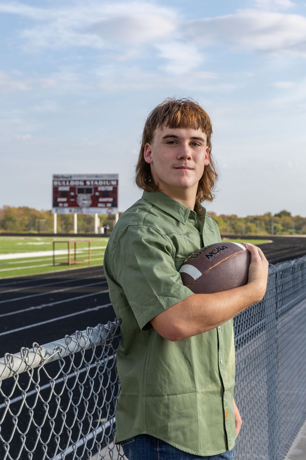 young man holding a football