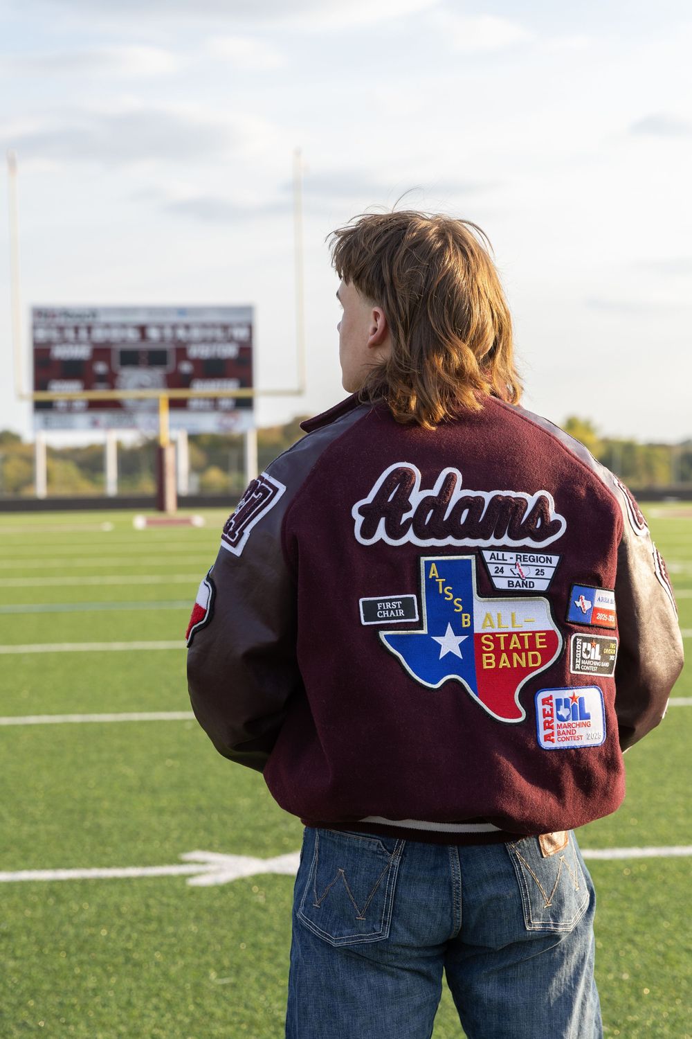 senior portraits on the football field, close up picture of his accolades on his letterman jacket
