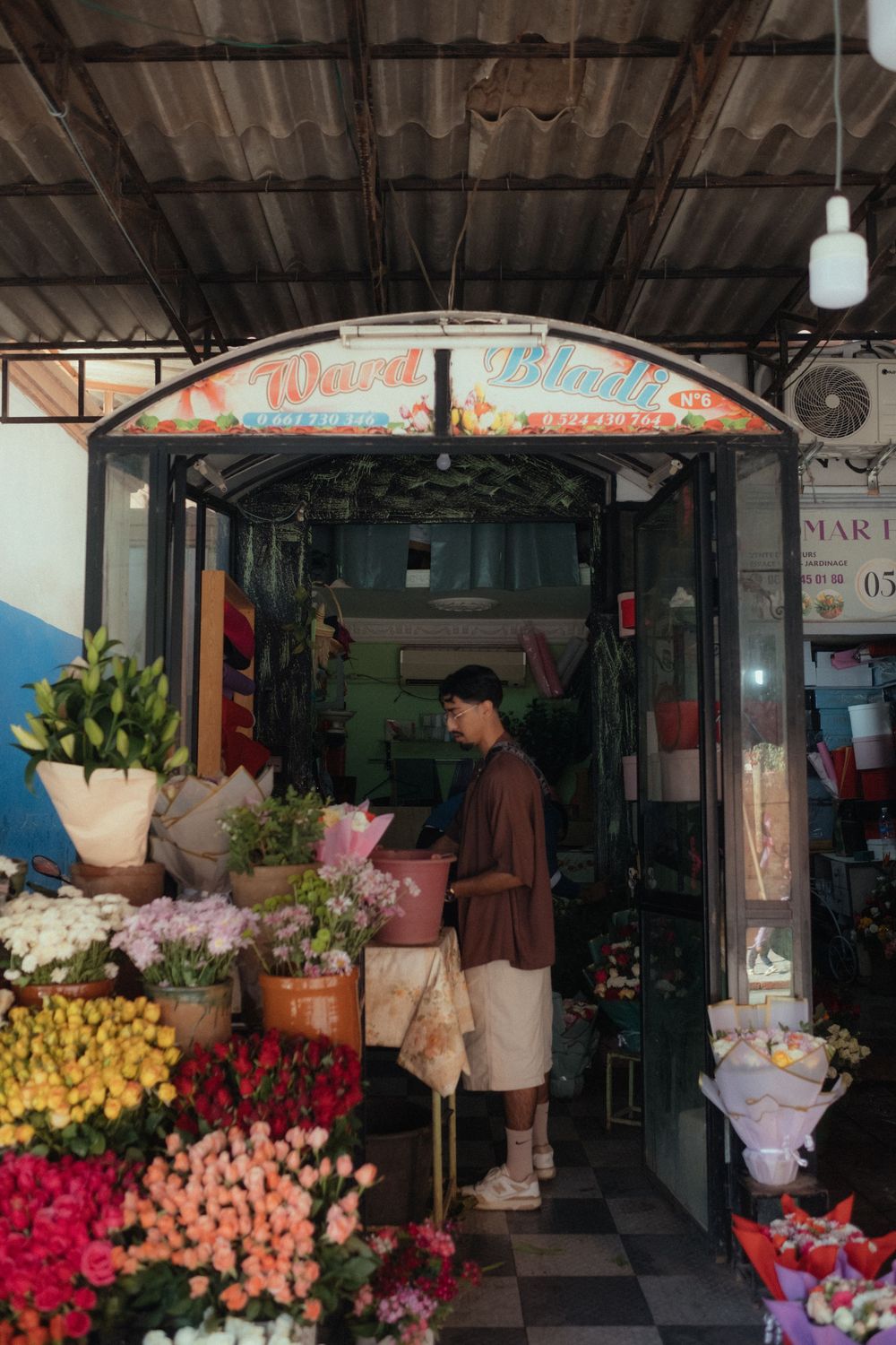 candid photo of groom in the flower market in Morocco during destination wedding
