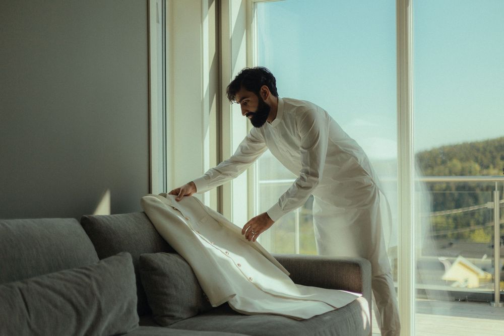 Grooms preparation photo on the morning of the wedding wearing Pakistani attire in Oslo, Norway