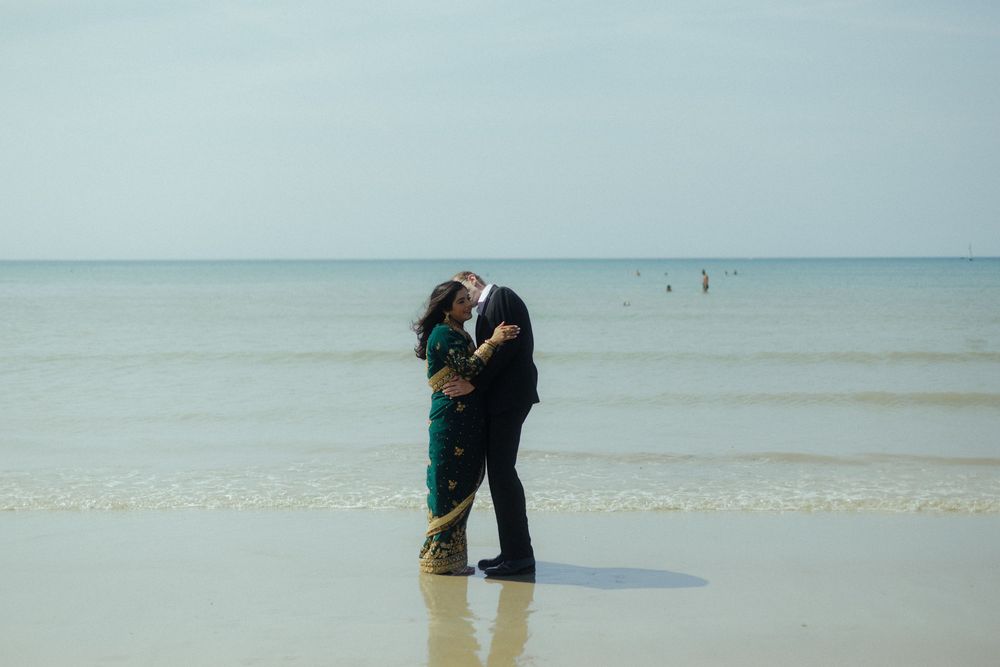 Bride and groom in an embrace on the beach South of France destination wedding