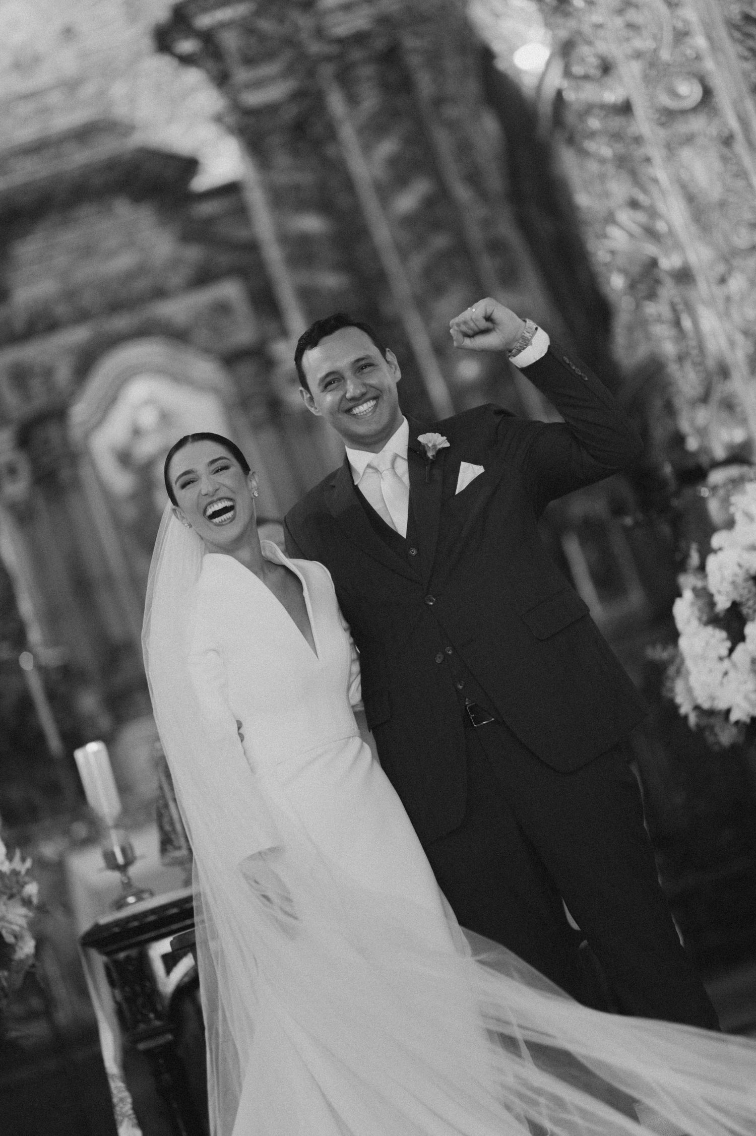 A romantic dance moment under string lights at an evening outdoor wedding reception.