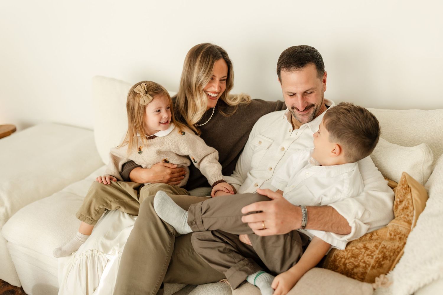 Young couple tenderly cradling their newborn baby together indoors.