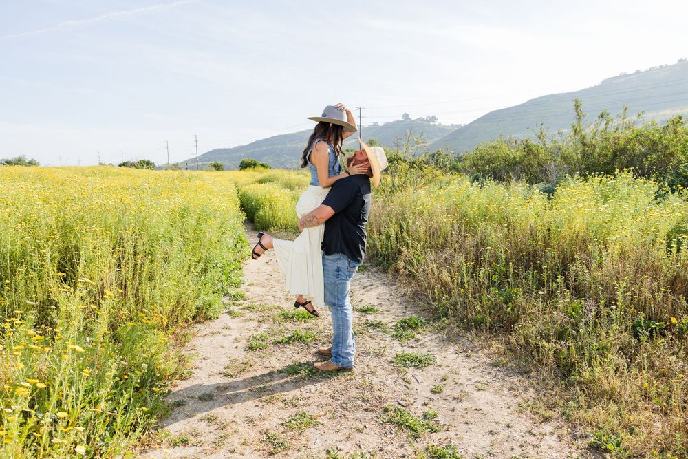 Engaged couple in a field in San Juan Capistrano