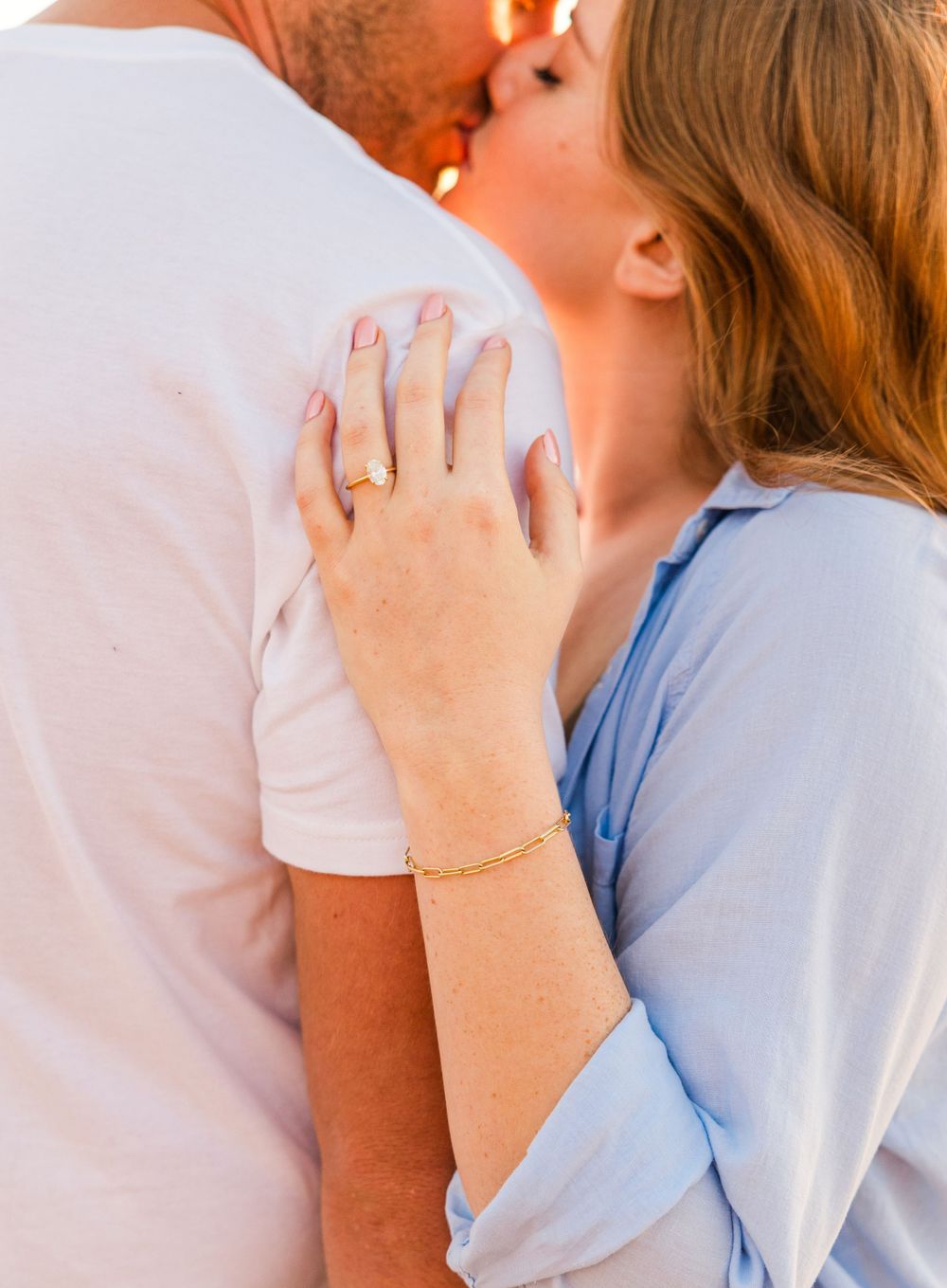 Engaged couple sharing a kiss in San Clemente