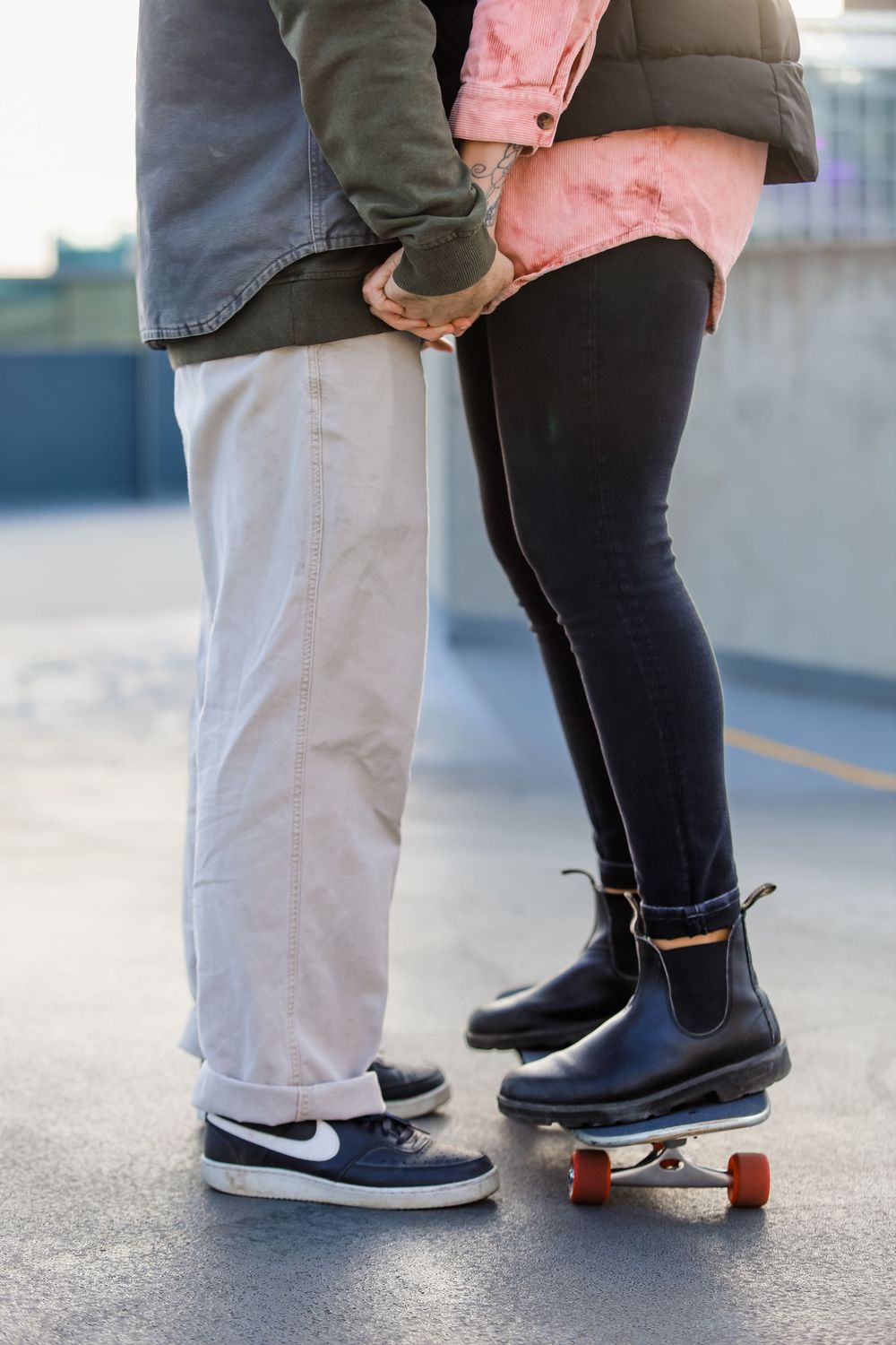 Close-up of feet showing couple standing together on pavement.