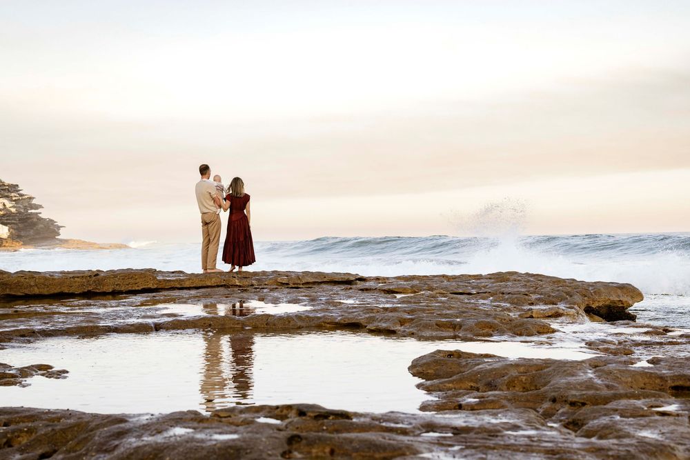 barefoot family walking at the beach during golden light session