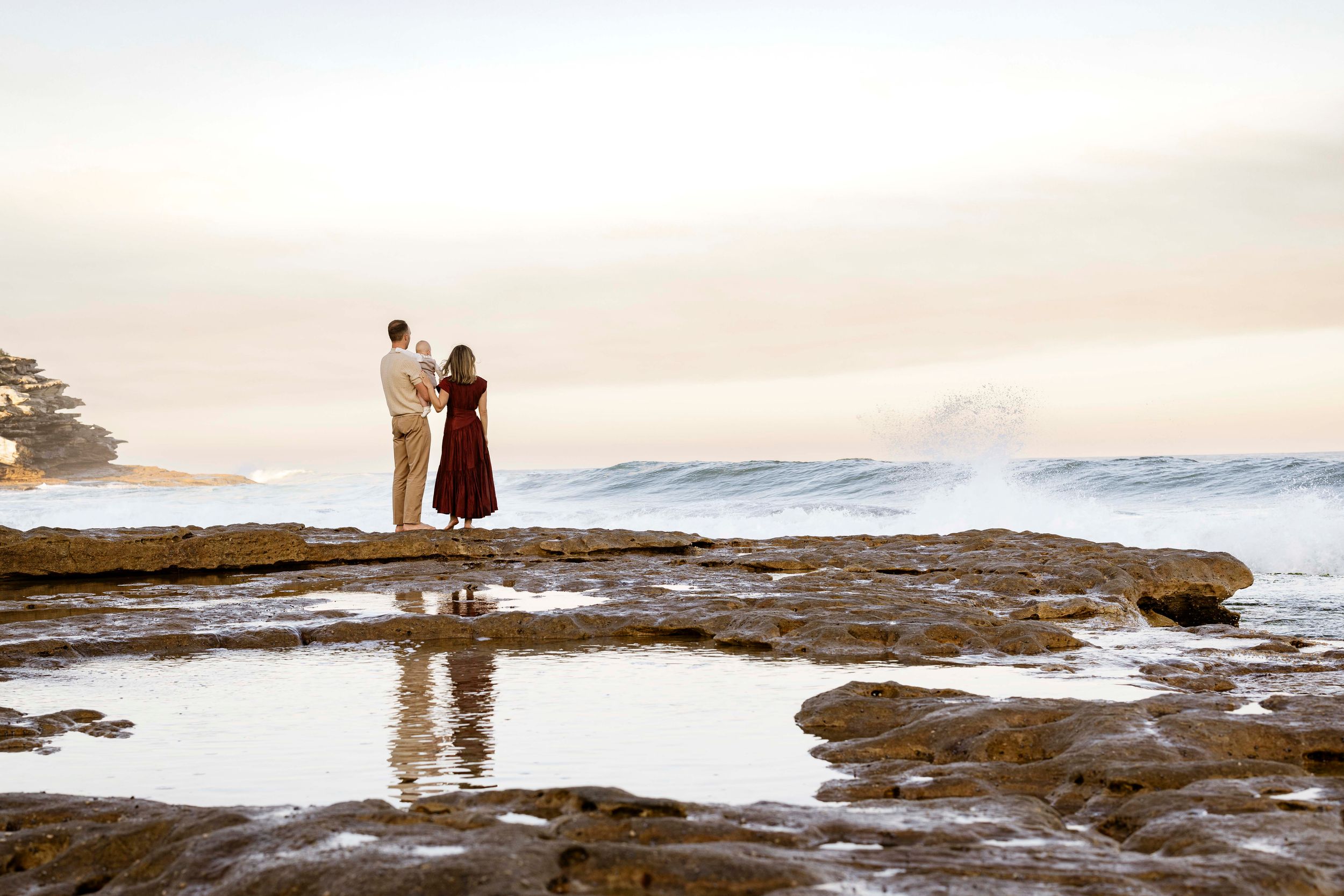 barefoot family walking at the beach during golden light session