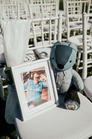 A sequence of photos showing a small plush toy and framed photo displayed on white chairs at what appears to be an event setup.