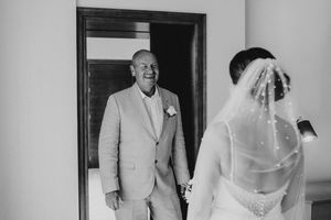 A black and white photo collage shows someone in a light colored suit walking through doorways in multiple frames.