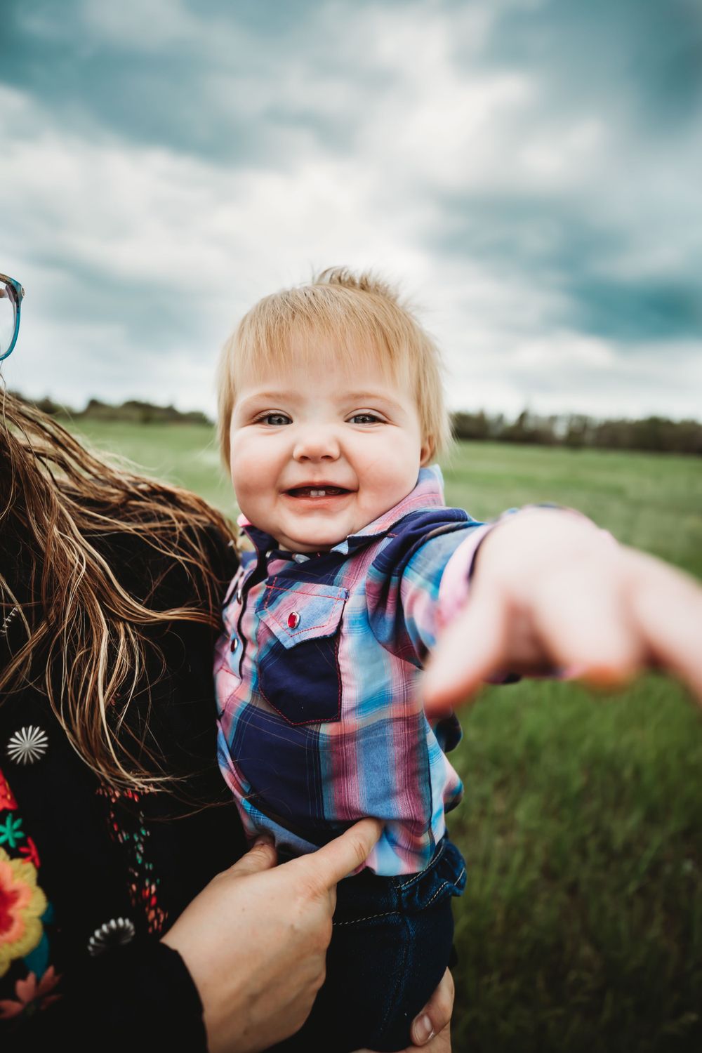 Little girl smiling and reaching for the camera in Dickson, TN