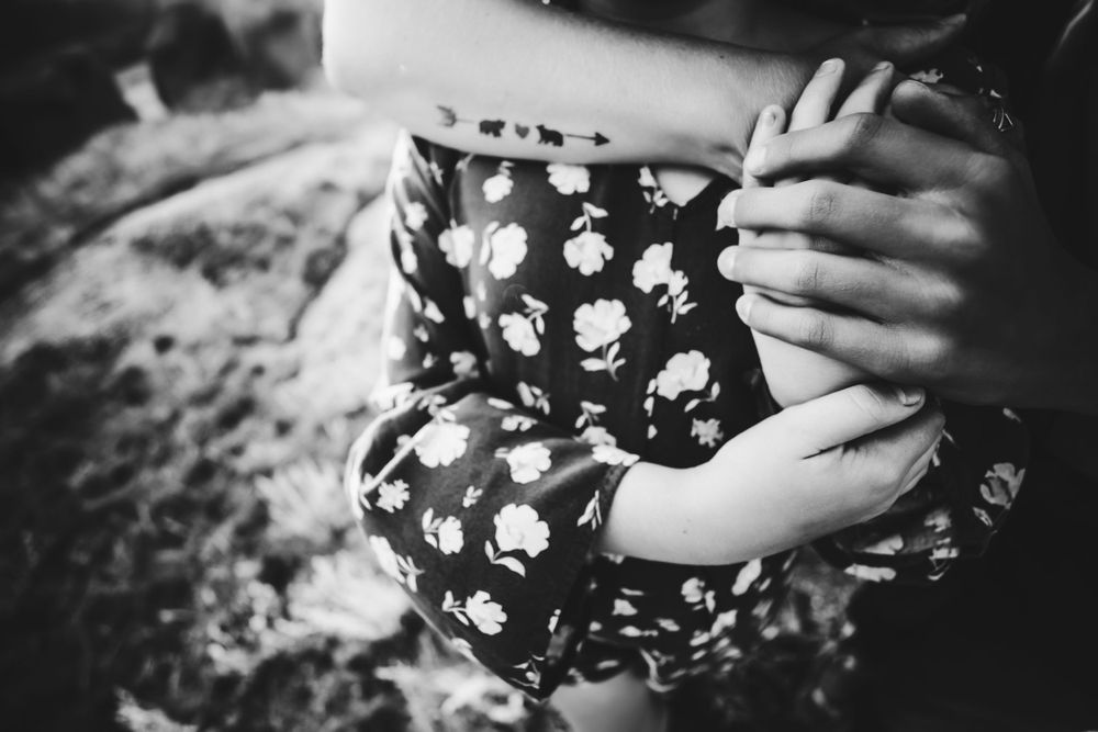 Mom's arms holding daughter in black and white Dickson, TN