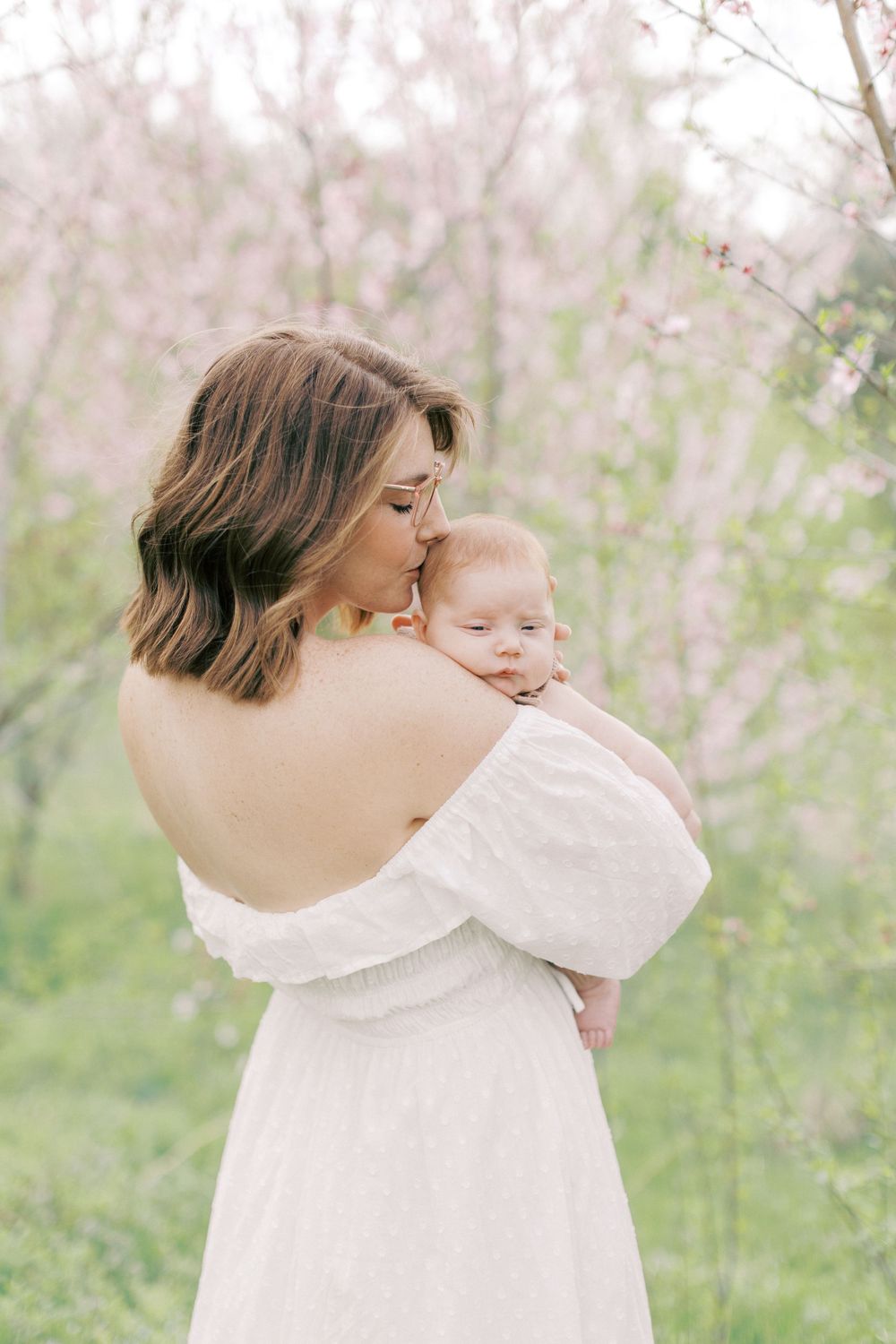 Intimate portrait in a spring garden with blooming trees.