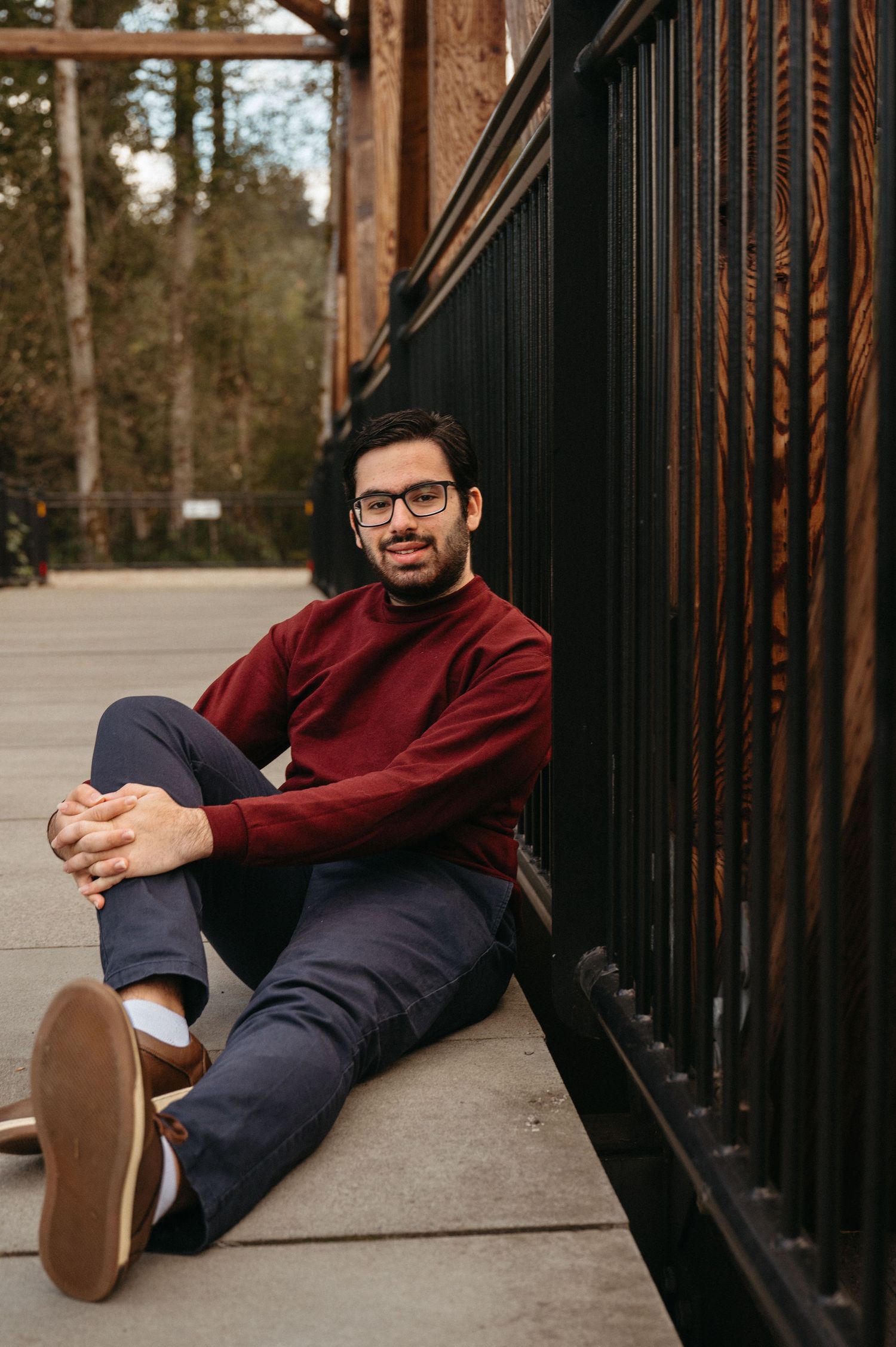 Creative portrait series showing relaxed poses against metal railings outdoors.