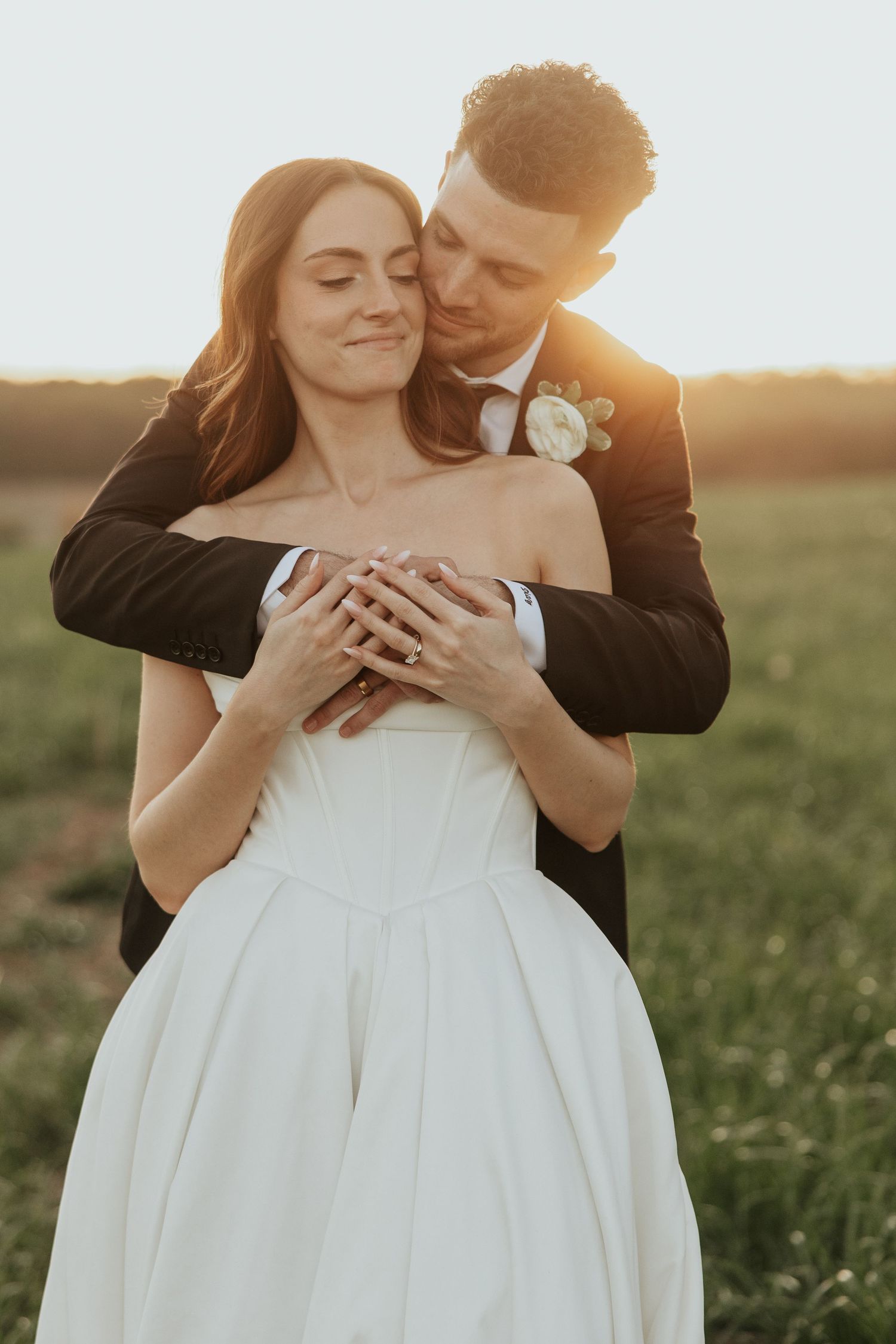 Couple dancing in elegant white room with chandelier and checkered floor.