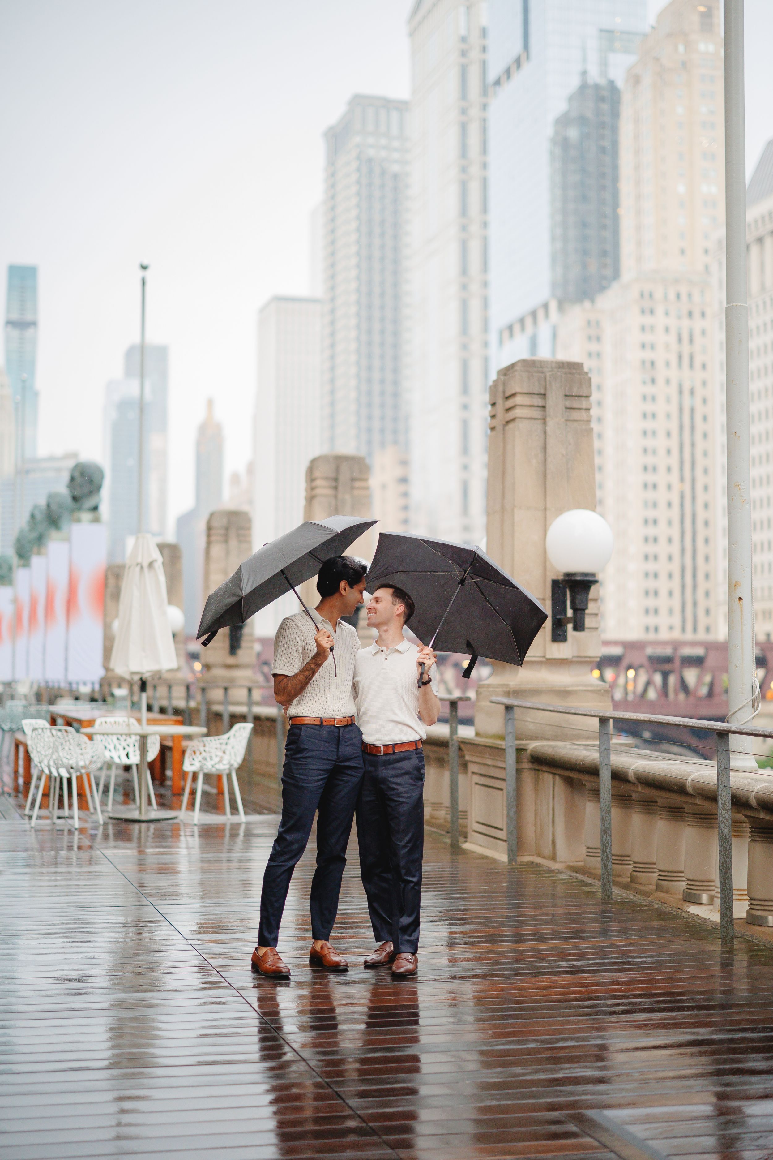 A couple shares a romantic kiss under umbrellas on a rainy day at the Bund waterfront in Shanghai.