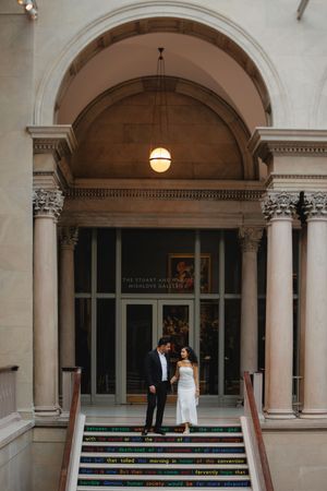 Elegant arched colonnade with classical columns and pendant lighting creates a romantic architectural setting.