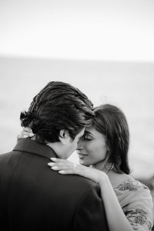A romantic black and white photo series showing a couple in an intimate embrace and kiss.