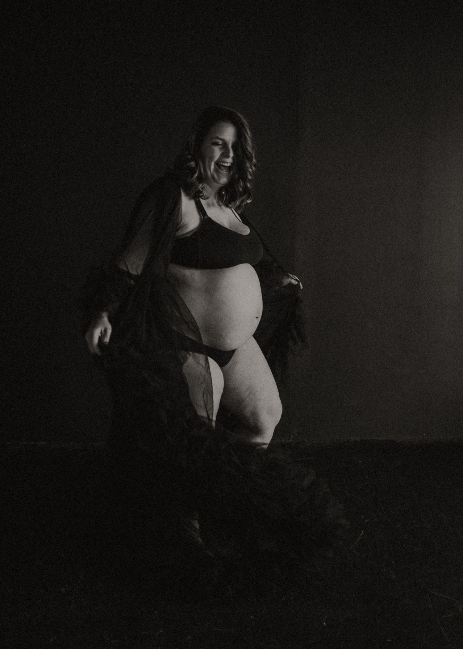 A dramatic black and white photo series showing abstract body shapes and silhouettes in dark lighting.