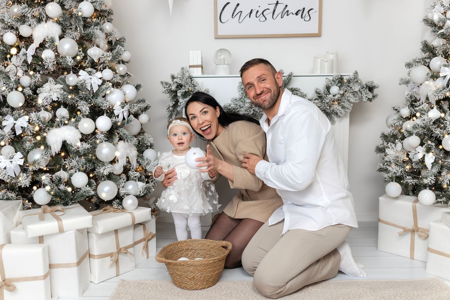 Two children holding Christmas gift in festive holiday setting.