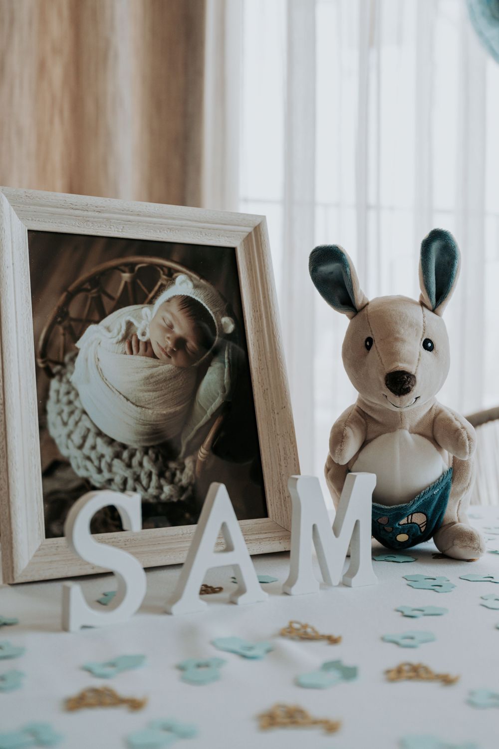 Decorative display with stuffed animals and letters spelling 'LIAM'.