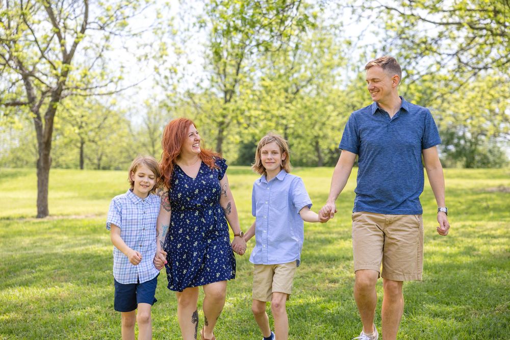 A family walks together holding hands at their Raleigh Spring mini session.