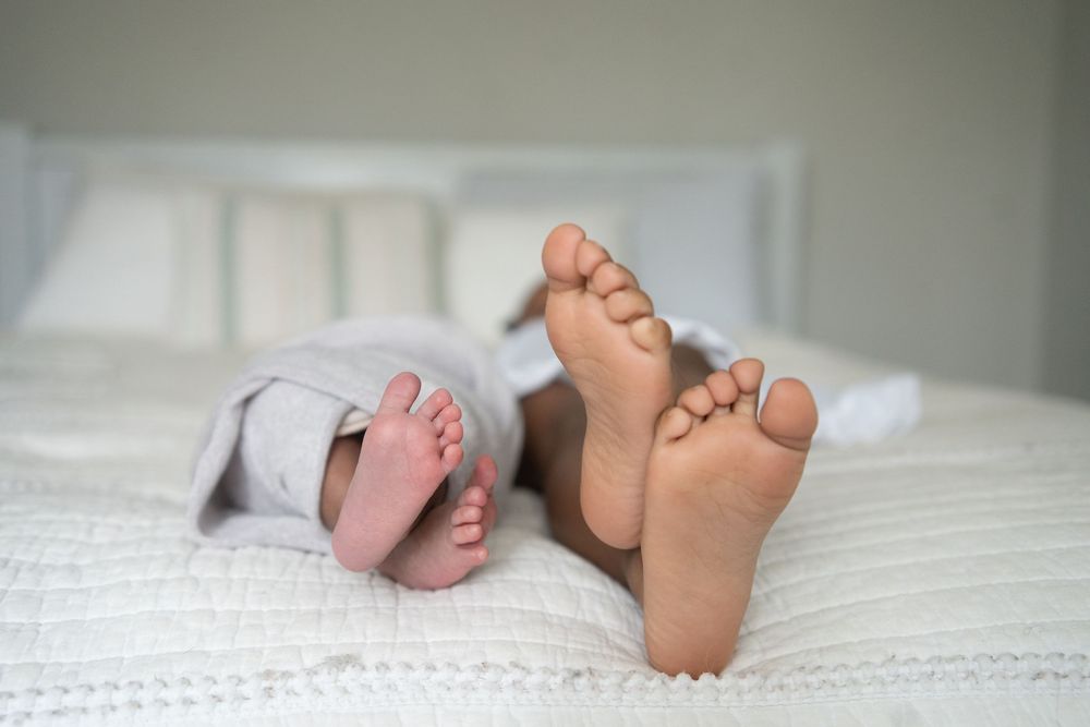 Newborn baby boy in Marietta GA feet with his sisters feet