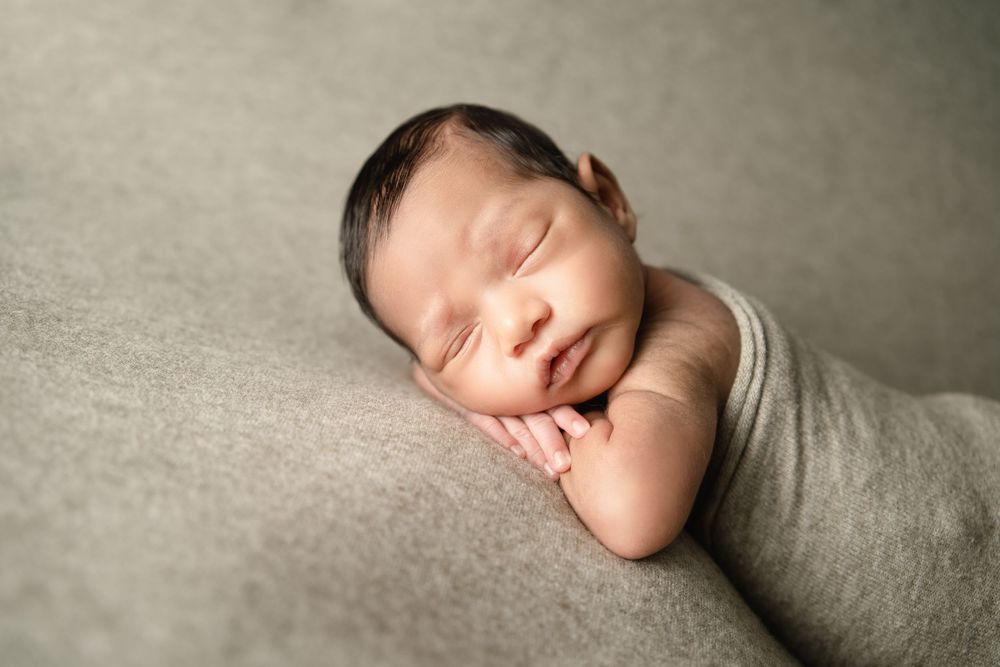 Newborn baby boy in Marietta GA on a green backdrop