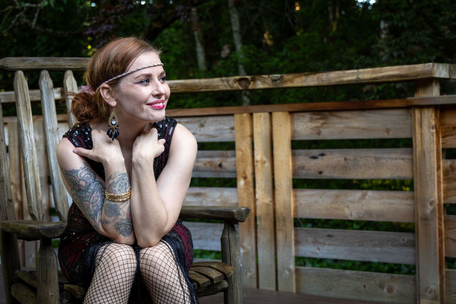 Brianne wearing her 1920 flapper dress leaning forward and a wooden chair