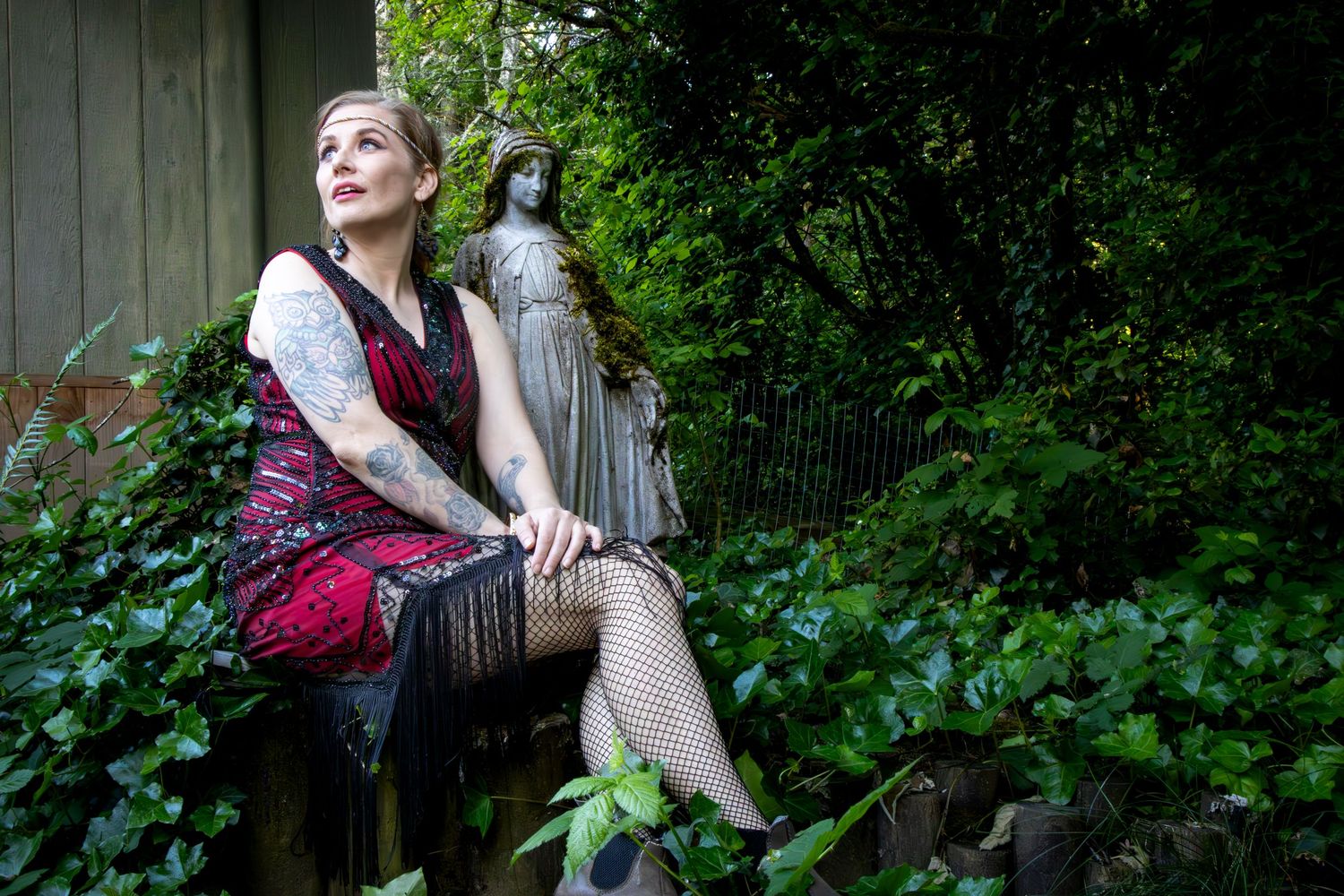 Breeze in the garden sitting next to a statue looking it