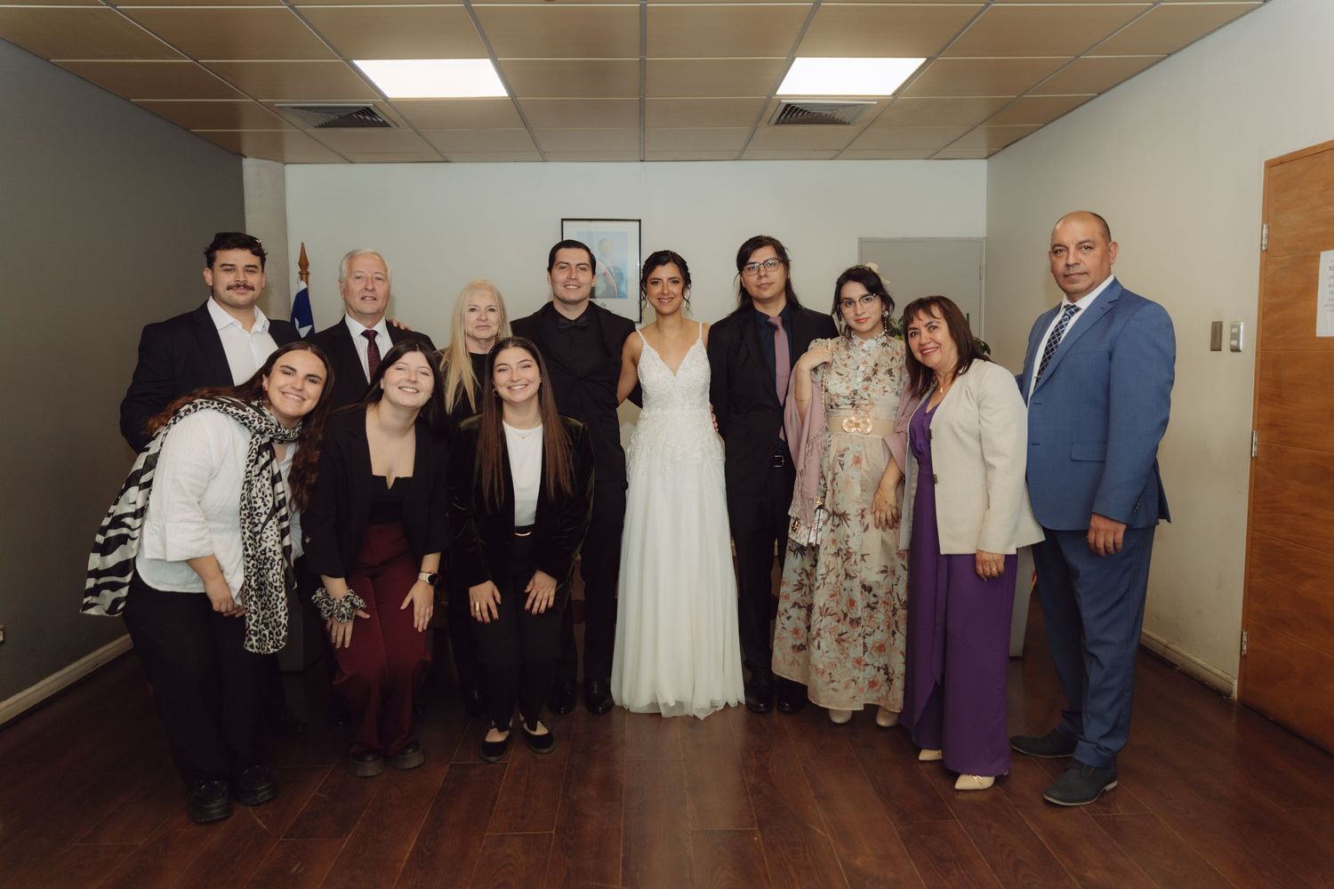 Newlywed couple celebrates with large group of family and friends after civil wedding.