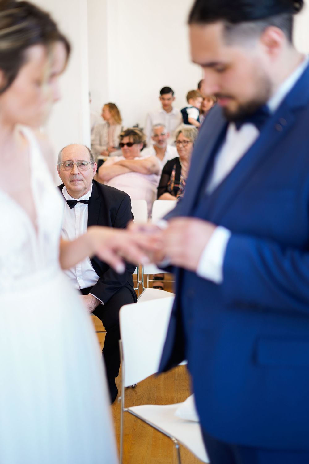 Wedding ceremony moment in an intimate indoor setting.